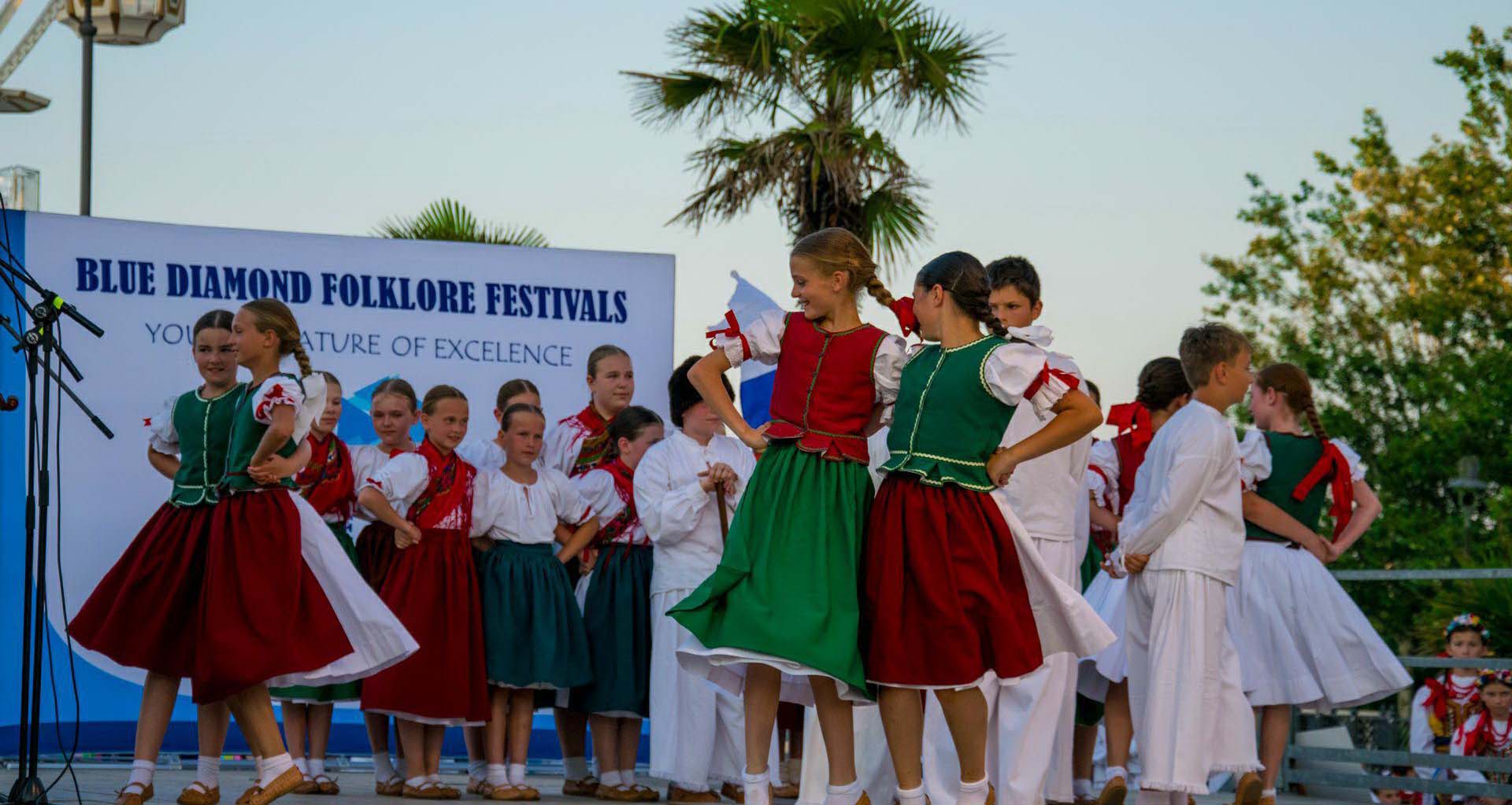 Folklore ensembles in traditional costume performing at an international Blue Diamond folklore festival